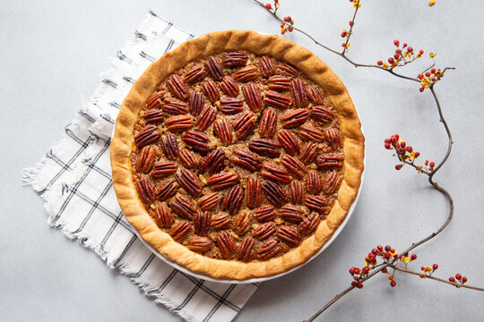 Perfectly Decorated Whole Pecan Pie with Branch of Bittersweet Berries
