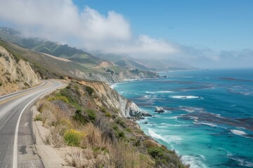 Fototapeta premium Coastal Highway Winding Through a Foggy Landscape