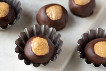 Smooth and Creamy Buckeye Chocolate and Peanut Butter Candies / Chocolates on White Background