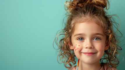Portrait a Cute little smiling professional artist with a paintbrush on color background. Happy funny little preschool child pretending artist looking at camera with copy space for text