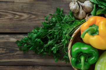 bell peppers and fresh basil, dill, parsley, cilantro, tomatoes, garlic, asparagus on a wooden table. top view. Flat lay