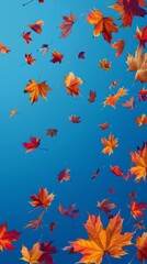 Vivid autumn leaves in shades of orange and red float gracefully against a clear blue sky, capturing the essence of fall's natural beauty and tranquility.
