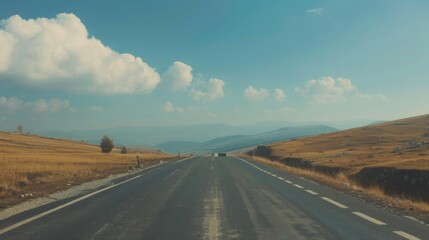 Fototapeta premium Asphalt Road Leading Through Mountains