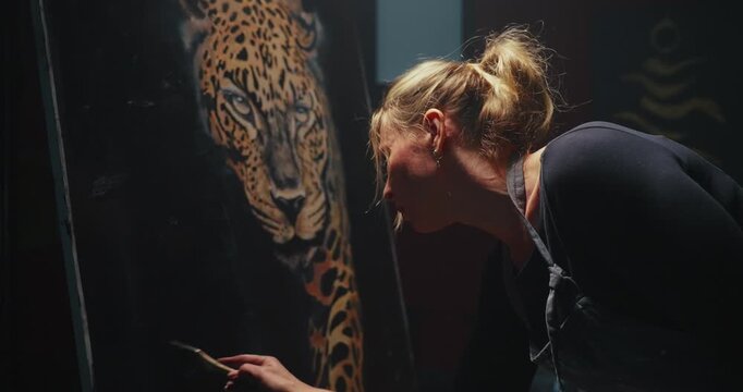 Woman Painting Leopard on Wall