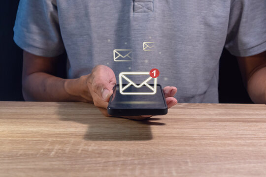Man holding a mobile phone with email notification, new message or social media notification.