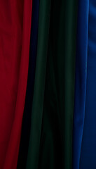 Close up of fabric texture. An abstract minimalist background featuring Deep Red, Forest Green, and Royal Blue. Perfect for bold and vibrant visuals
