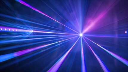 Obraz premium Bright laser light beams in blue and violet on a dark backdrop