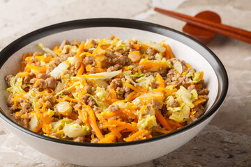 Eggroll in a bowl sauteed ground meat with vegetables in flavor packed sauce closeup on the table. Horizontal