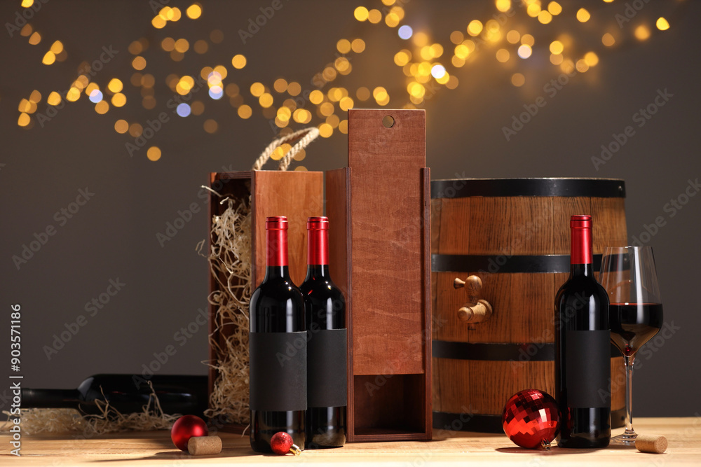 Sticker Bottles of wine, glass, wooden gift boxes, barrel corks and red Christmas balls on table