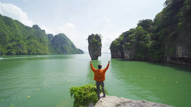 A tourist travel at Khao Phing Kan, Ko Ta Pu, Phang Nga, lush green trees from above in tropical forest in national park in summer season. Natural landscape background.