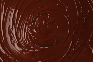 Delicious melted chocolate as background, top view