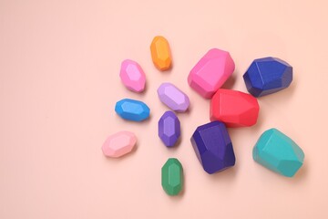 Many colorful balancing stones on beige background, top view. Space for text