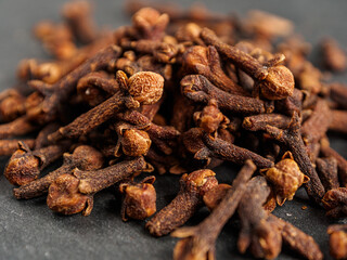 A close-up of aromatic cloves, highlighting the texture and rich color