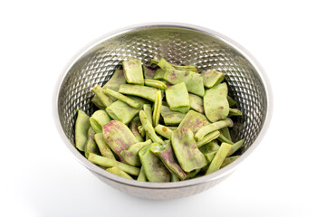 A bowl of broken lentils on a white background