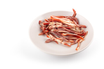 A plate of chopped pig ears on a white background