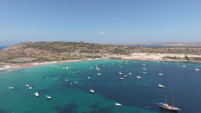 Moorings Near Triq Il-Marfa In Mellieha Bay With Red Tower In The Background In Malta. Aerial Shot