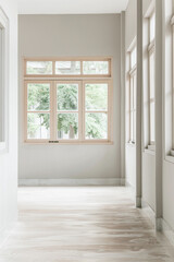 Fototapeta premium Property interiors design composition with minimal furniture, a mirror next to a large window and plain lighting. Elegant Residential interiors with copyspace.