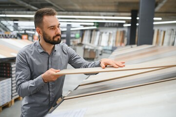 Man choosing flooring in hardware store