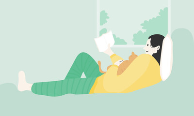 A woman reading book indoor with a cat.