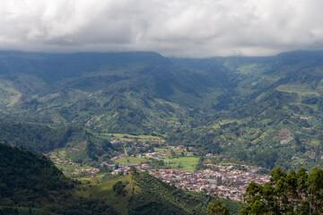 Fototapeta premium Cityscape of Jardin, Jardín, Antioquia, Colombia. Awesome landscape with the green Andes Mountains. Cloudy sky.