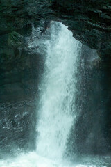 Huge waterfall in the Cueva del Esplendor, cave of splendor, Jardin, Jardín, Antioquia, Colombia. Creative and artistic composition with rocks, water flowing and splashing.