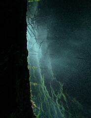 Creative and artistic composition in the Cueva del Esplendor, cave of splendor, Jardin, Jardín, Antioquia, Colombia. Dark abstraction with rock and droplets in a ray of light.