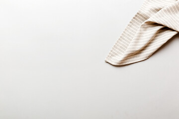 top view with gray kitchen napkin isolated on table background. Folded cloth for mockup with copy space, Flat lay. Minimal style