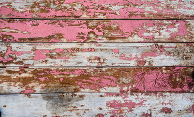 Empty wooden planks painted and weathered in red