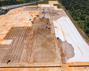 Aerial view of construction site ground process, showing progress in development in Malaysia.