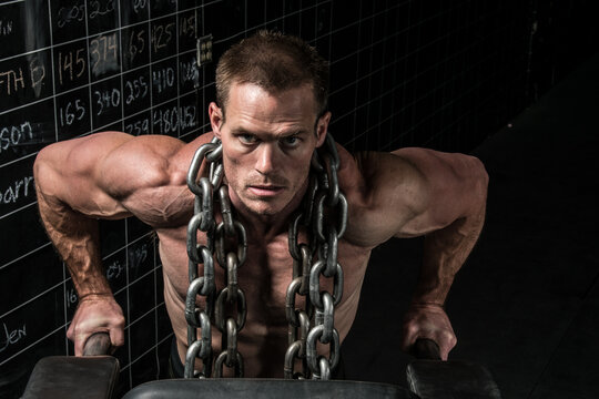 Man dips with heavy chains