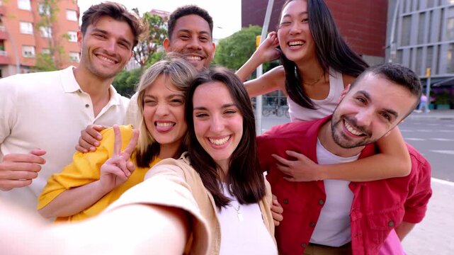 Diverse group of young people having fun taking selfie portrait together outside. Pretty woman smile at camera standing together with college student friends. Youth community and friendship concept.