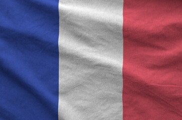France flag depicted on folded wavy fabric of old cloth close up