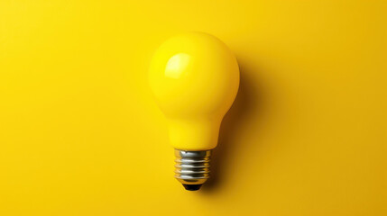 A bright light bulb set against a vibrant yellow backdrop, emphasizing simplicity and modern design in a minimalist style.