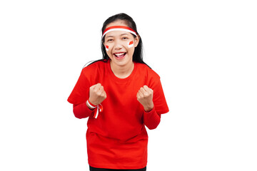 An excited Indonesian woman celebrating Indonesia's independence day standing while raising her...