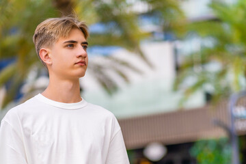 Portrait of a dreamy young man on a summer background. 