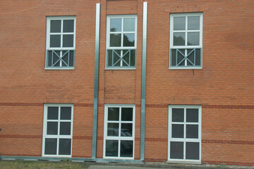 Obraz premium Modern beautiful white frame window on a brick wall of a house