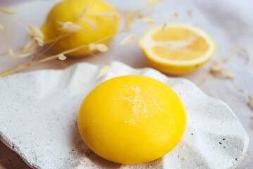 Natural handmade soap with lemon oil  on a white stone plate .Typical Italian soap from Amalfi ,Italy 