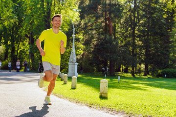 Radiant jogger in vibrant park, basking in morning sun.
