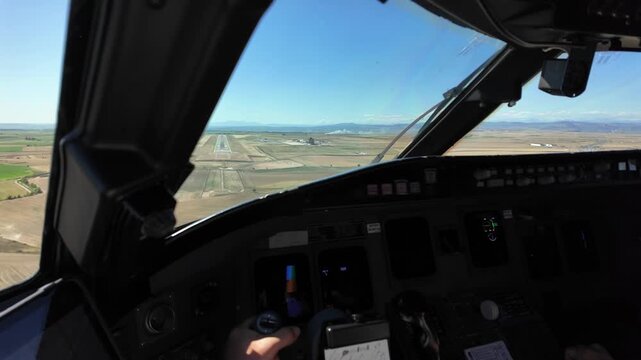 Immersive pilot POV in a real time approach for landing at Lleida airport, Spain, in a splendid sunny summer day. Captain piloting the jet. 4K 60FPS