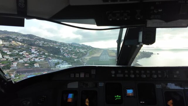 Immersive pilot perspective in a real time landing at dangerous Madeira Funchal airport in Portugal, in a windy and cloudy day. 4K 60FPS