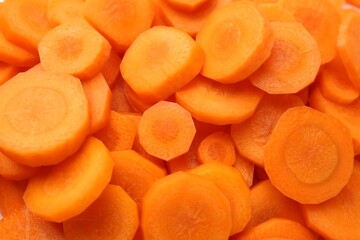 Slices of fresh ripe carrot as background, top view