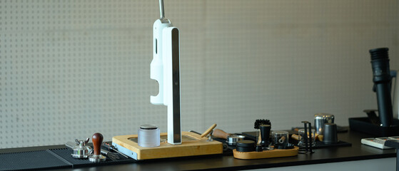 Stylish modern cafe interior with espresso machine and various barista tools on stone counter