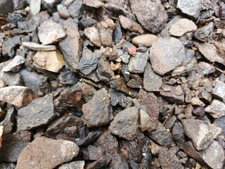pile of stone close up. Small rocks ground. Crushed stone road building material gravel texture. Small stone construction material rock.