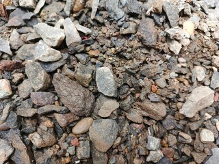 pile of stone close up. Small rocks ground. Crushed stone road building material gravel texture. Small stone construction material rock.