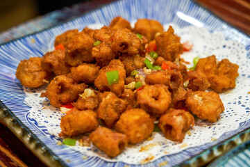A plate of delicious Chinese food, deep fried crispy pig intestines