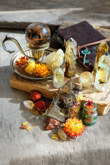 gemstone crystals, amulets, witchcraft items, spell book on wooden table. wiccan Witchcraft,...