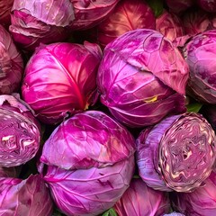 Obraz premium Vibrant purple cabbages stacked together, showcasing their rich color and texture.