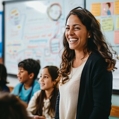 Smiling woman with long curly hair, engaging with students in a vibrant classroom filled with colorful notes.