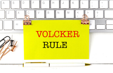VOLCKER RULE text on yellow sticky on keyboard