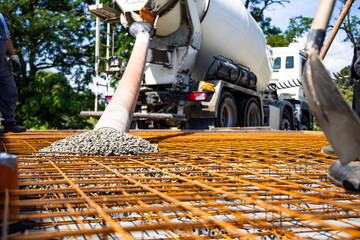 Concrete Mixer Truck Pouring Concrete onto Rebar Framework